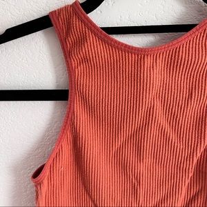 A orange crop top that is perfect to workout in.